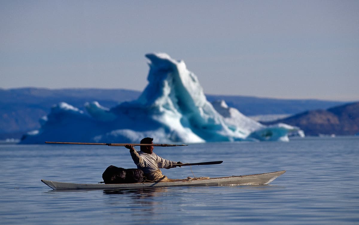 Inuit narwhal hunter Mamarut Kristiansen just throwing his harpoon from his kayak, Qaanaaq, Greenland, Arctic.