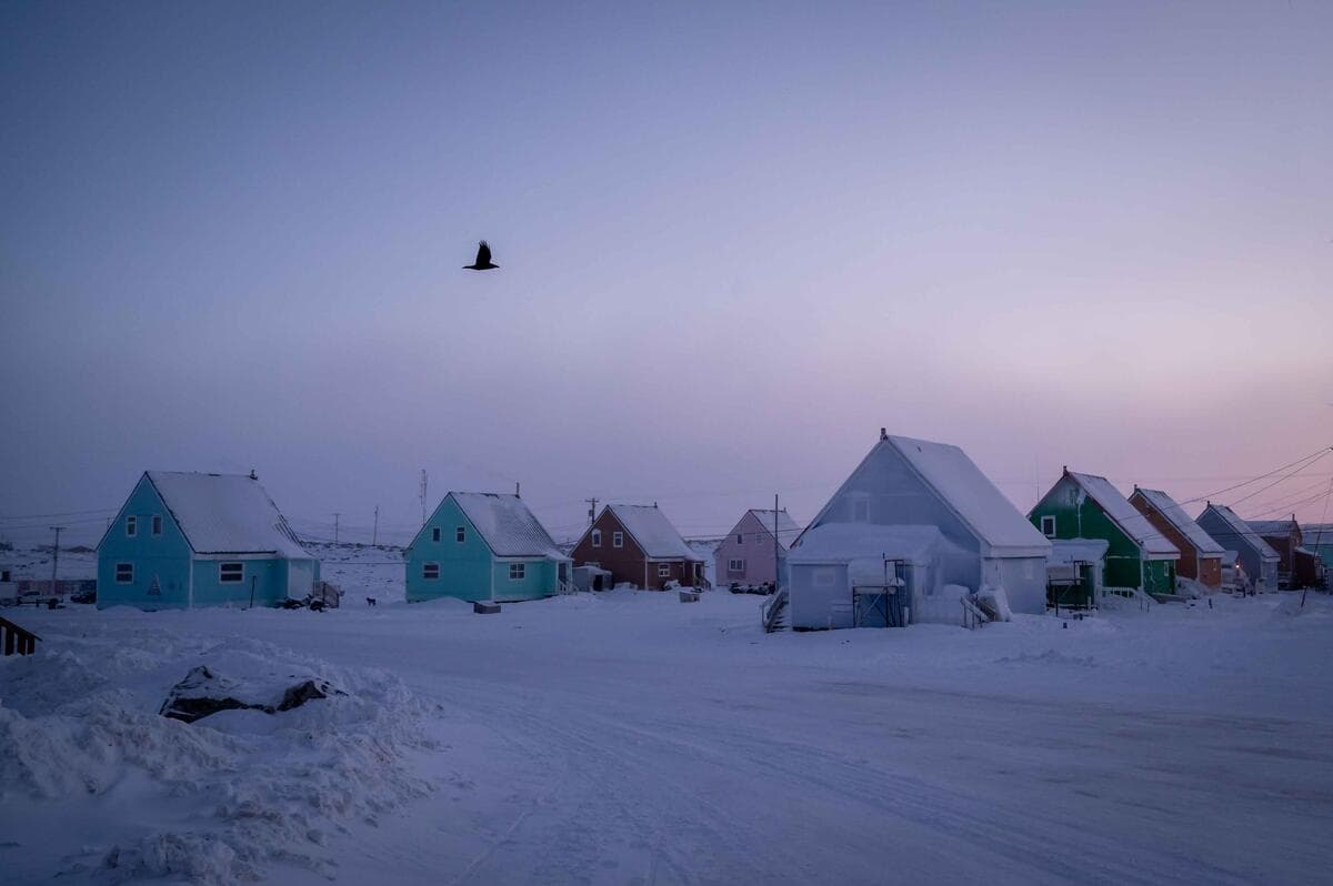 The sun sets on the colourful, snow-covered homes of Taloyoak, Nunavut.