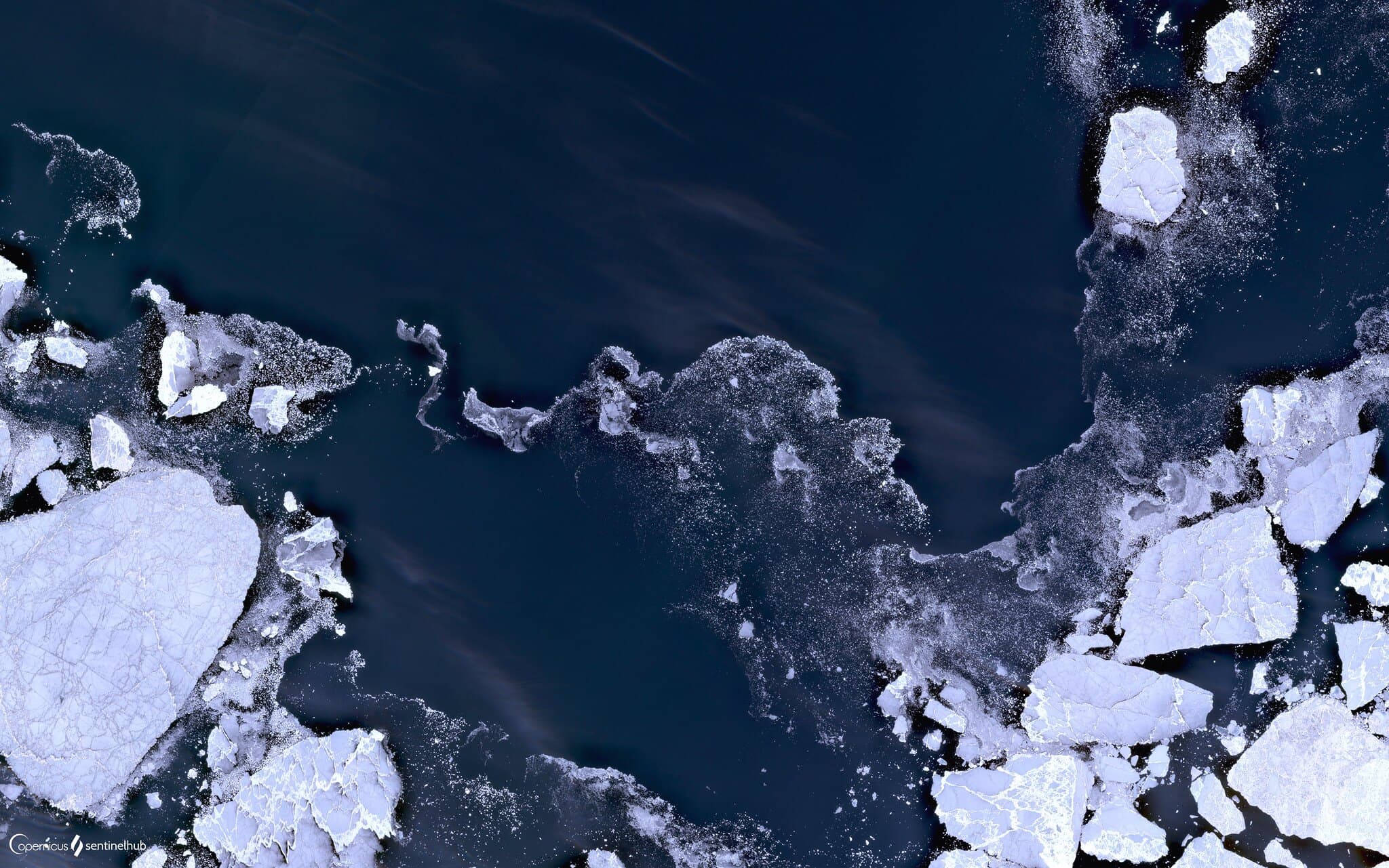 An aerial view of sea ice packed together in the Arctic Ocean.