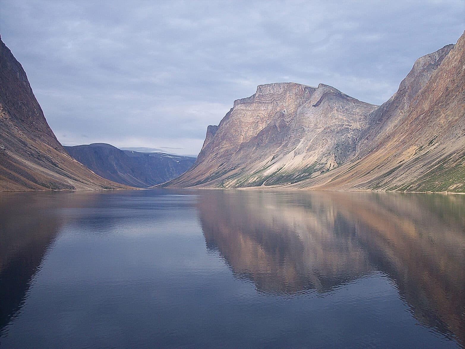Image of Torngat Mountains in Labrador, Canada with a lake in between the mountains.