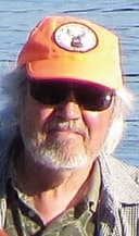 Monte Hummel, wearing big sunglasses and an orange cap