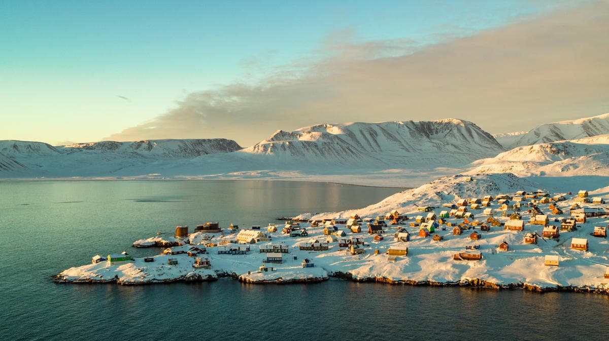 Aeriel photo of the colourful houses of Ittoqqortormit, a remote settlement in Eastern Greenland.