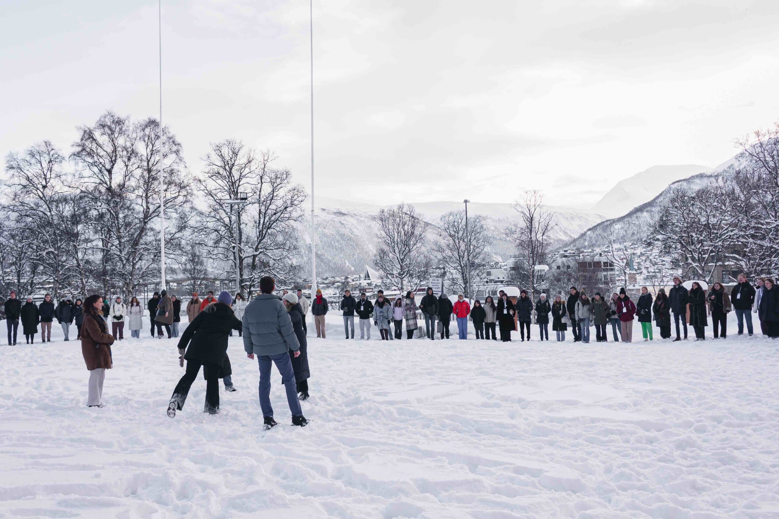 Youth from Arctic countries gathering together outside in the snow.