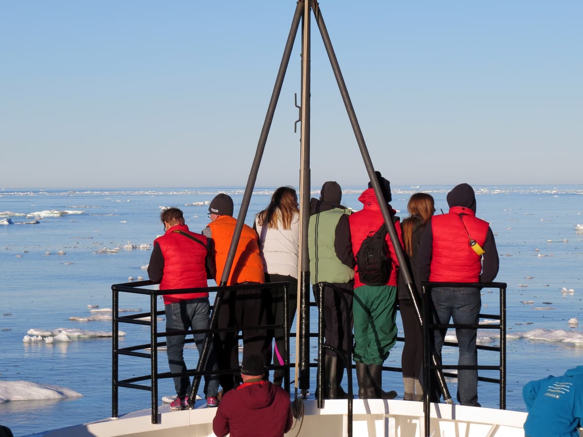 Students on an expedition ship observing sea ice.